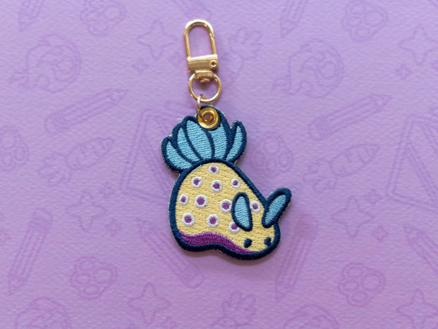 Kunies Nudi | Embroidered Charm